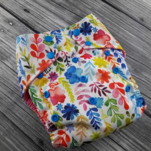 Watercolor Wildflowers Diaper on a grey wooden background